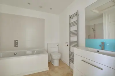 a bathroom with a tub and a toilet and a sink at 6 Bed in Constantine Bay oc-p00571 in St Merryn