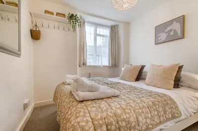 a bedroom with a bed with a stuffed animal on it at 2 Bed in Padstow oc-p00572 in Padstow