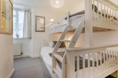 a bedroom with a bunk bed and a staircase in a room at 2 Bed in Padstow oc-p00572 in Padstow