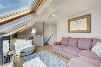 a living room with a purple couch and two chairs at 2 Bed in Crackington Haven oc-p00596 in Crackington Haven