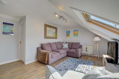 a living room with a purple couch in a attic at 2 Bed in Crackington Haven oc-p00596 in Crackington Haven