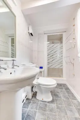 a white bathroom with a sink and a toilet at 2 Bed in Penzance oc-p00597 in Saint Erth