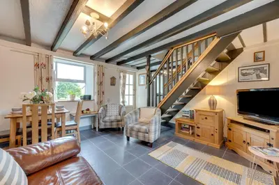 a living room with a couch and a staircase at 2 Bed in Penzance oc-p00597 in Saint Erth