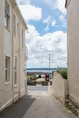 an alleyway between two buildings with a view of the ocean at 2 Bed in Marazion oc-p00598 in Marazion