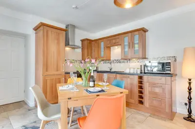 a kitchen with a wooden table and chairs at 2 Bed in Marazion oc-p00598 in Marazion