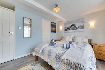 a bedroom with a large bed with blue walls at 2 Bed in Marazion oc-p00598 in Marazion