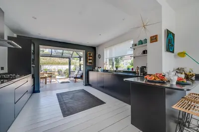 a kitchen with black and white cabinets and a counter at 4 Bed in Mawgan Porth oc-p00608 in Mawgan Porth