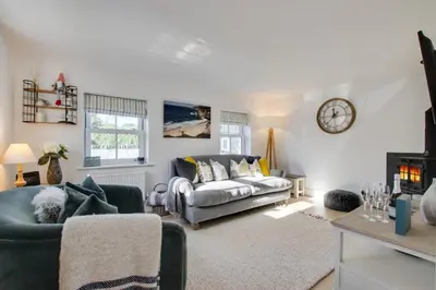a living room with a couch and a clock on the wall at 2 Bed in St. Merryn oc-p00607 in St Merryn