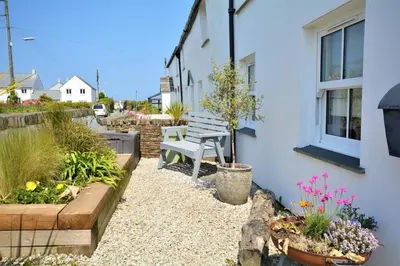 a garden with a bench next to a building at 2 Bed in St. Merryn oc-p00607 in St Merryn