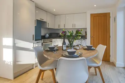 a kitchen and dining room with a wooden table and chairs at 2 Bed in St. Merryn oc-p00607 in St Merryn
