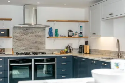 a kitchen with blue cabinets and a counter top at 5 Bed in Padstow oc-p00628 in Padstow