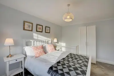 a bedroom with a bed and a table and a lamp at 5 Bed in Padstow oc-p00628 in Padstow