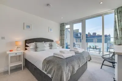 a bedroom with a large bed with a large window at 3 Bed in Newquay oc-p00631 in Newquay