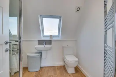 a bathroom with a toilet and a sink and a window at 3 Bed in Newquay oc-p00631 in Newquay