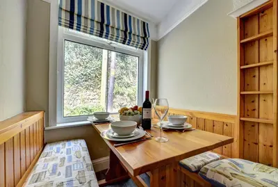 a dining room with a table and a window at 2 Bed in Padstow oc-p00632 in Padstow