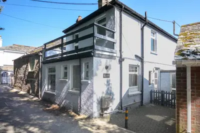 an old white building on the side of a street at 2 Bed in Padstow oc-p00632 in Padstow