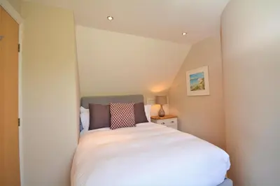 a small bedroom with a white bed in a room at 2 Bed in Little Petherick oc-p00635 in Little Petherick