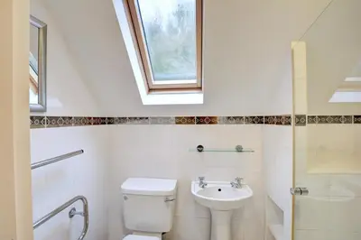 a bathroom with a toilet and a sink and a window at 2 Bed in Little Petherick oc-p00635 in Little Petherick