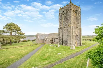 an old church with a tower in the middle of a field at 1 Bed in St. Merryn oc-p00645 in St Merryn