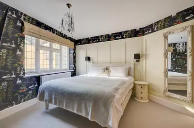 a bedroom with a bed and a mirror at 3 Bed in Fowey oc-p00647 in Fowey