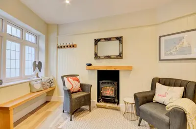 a living room with two chairs and a fireplace at 3 Bed in Fowey oc-p00647 in Fowey