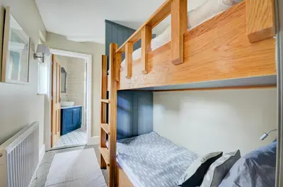 a bedroom with bunk beds in a tiny house at 3 Bed in Fowey oc-p00647 in Fowey