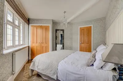a bedroom with a large bed and a window at 3 Bed in Fowey oc-p00647 in Fowey