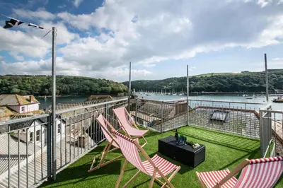 two chairs on a balcony with a view of the water at 3 Bed in Fowey oc-p00647 in Fowey