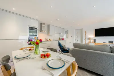 a kitchen and living room with a table and a couch at 2 Bed in Padstow oc-p00655 in Padstow