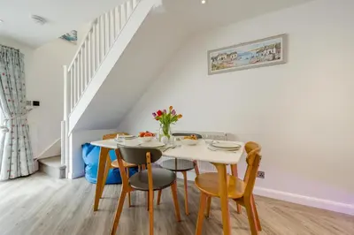 a dining room with a white table and chairs at 2 Bed in Padstow oc-p00655 in Padstow