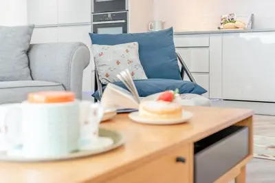 a coffee table with a plate of food on it at 2 Bed in Padstow oc-p00655 in Padstow