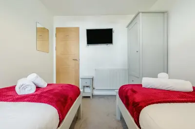 a bedroom with two beds and a tv on the wall at 2 Bed in Padstow oc-p00655 in Padstow