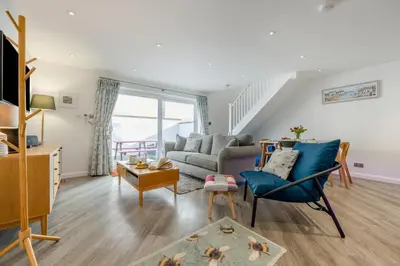 a living room with a couch and a chair at 2 Bed in Padstow oc-p00655 in Padstow