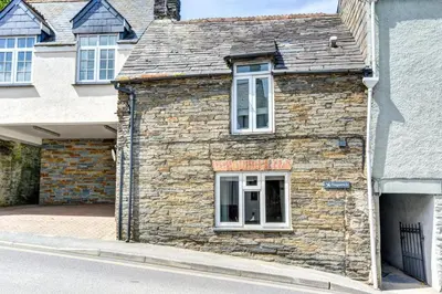an old stone building with a window on a street at 2 Bed in Padstow oc-p00670 in Padstow