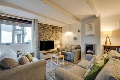 a living room with two couches and a fireplace at 2 Bed in Padstow oc-p00670 in Padstow