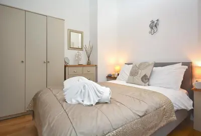 a bedroom with a bed with white sheets on it at 2 Bed in Padstow oc-p00670 in Padstow
