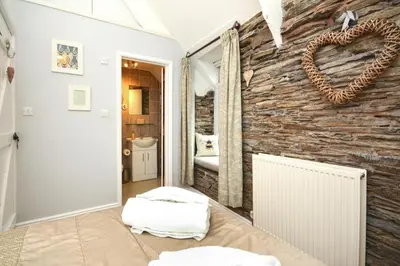 a room with a stone wall with a heart on it at 2 Bed in Padstow oc-p00670 in Padstow