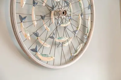 a clock with birds on it hanging on a wall at 2 Bed in Fowey oc-p00671 in Fowey