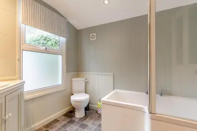 a bathroom with a toilet and a tub and a sink at 2 Bed in Fowey oc-p00671 in Fowey