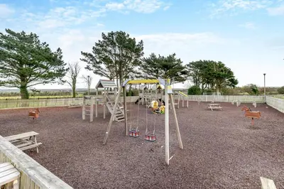 a playground with a swing set in a park at 2 Bed in St. Merryn oc-p00673 in St Merryn
