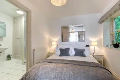 a bedroom with a large bed and a bathroom at 1 Bed in Padstow oc-p00685 in Padstow