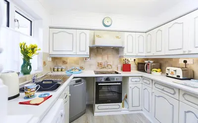 a white kitchen with white cabinets and a sink at 2 Bed in St. Ives oc-p00693 in Carbis Bay