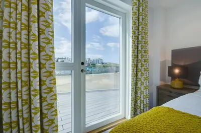 a bedroom with a window with a view of the water at 3 Bed in Perranporth oc-p00695 in Perranporth