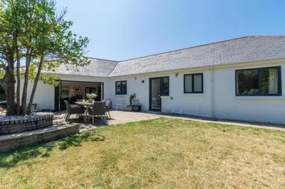 an image of a house with a yard at 4 Bed in Trevone oc-p00696 in Padstow