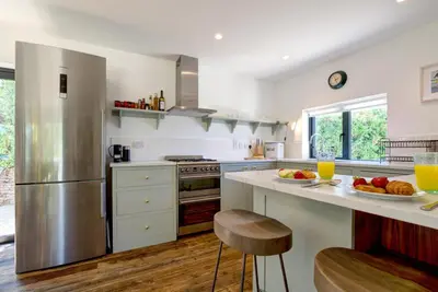 a kitchen with a stainless steel refrigerator and fruits on a counter at 4 Bed in Trevone oc-p00696 in Padstow