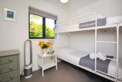 a bedroom with two bunk beds and a desk at 4 Bed in Trevone oc-p00696 in Padstow