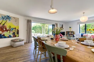 a dining room and living room with a table and chairs at 4 Bed in Trevone oc-p00696 in Padstow