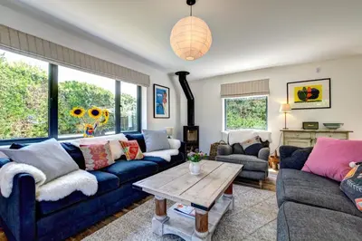 a living room with blue couches and a table at 4 Bed in Trevone oc-p00696 in Padstow