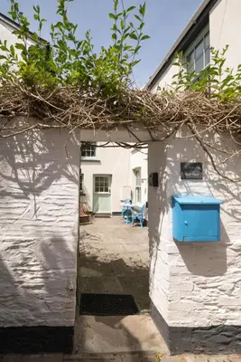 a small white building with a blue door at 2 Bed in Polruan oc-p00697 in Fowey
