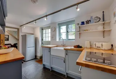 a kitchen with a sink and a refrigerator at 2 Bed in Polruan oc-p00697 in Fowey